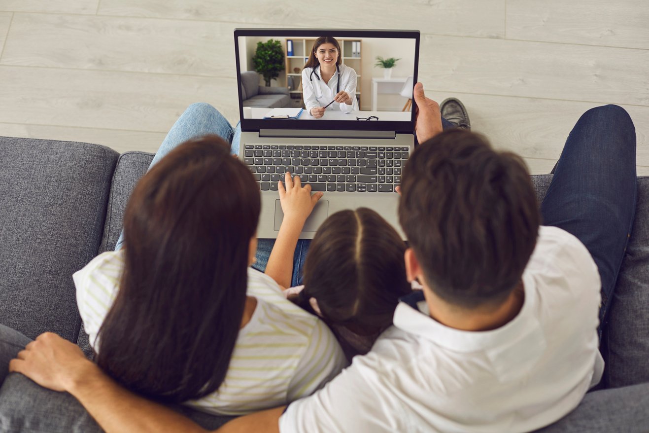 Family Talking to Doctor Online via Laptop at Home